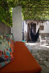 a table with pillows and a hammock on a patio at Maries Thasos Stone Villa in Mariaí