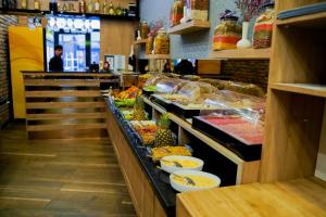 a buffet line in a restaurant with fruits and vegetables at Mai İnci Otel in Antalya