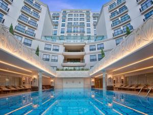 a large swimming pool in a large building at CVK Park Bosphorus Hotel Istanbul in Istanbul