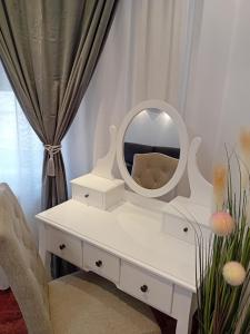 a white dressing table with a mirror on it at PERLA PREMIUM APARTMENT in Timişoara