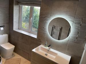 a bathroom with a sink and a toilet and a mirror at Stunning 4-Bed House in Wetherby near York in Wetherby