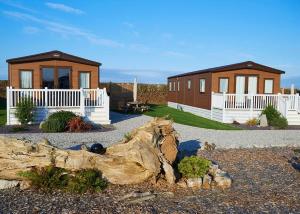 a couple of small houses and a log at Looe Coastal Retreat in Looe