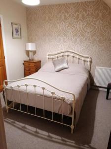 a bedroom with a bed with a pillow on it at Central 3 Bedroom Townhouse in Wick