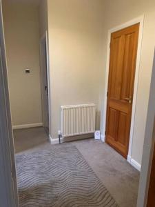 an empty room with a door and a rug at Central 3 Bedroom Townhouse in Wick