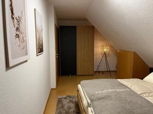 a bedroom with a staircase with a bed and a lamp at FeWo 2 an der historischen Bahnlinie in Leutkirch im Allgäu