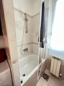 a bathroom with a tub and a shower at A.B Battistini Short Let's in Rome