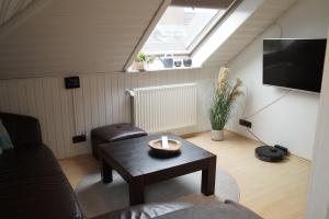 a living room with a table and a skylight at Ferienwohnung Robbe in Cuxhaven