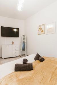 a bedroom with a large bed with a flat screen tv at Filoxenia Katerini in Katerini