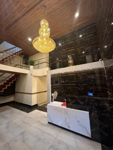 a lobby with a sink and a chandelier at TRI HOTEL in Mumbai