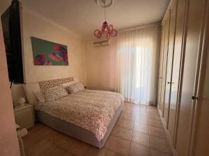 a small bedroom with a bed and a window at A.B Battistini Short Let's in Rome
