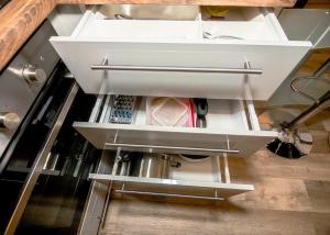 a kitchen with an open drawer with a food appliance at FerienWohnung A&S Heuchelheim in Heuchelheim +67 photos