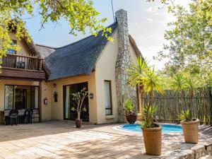an exterior view of a house with a swimming pool at Impala Cottage in Hoedspruit