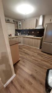 a large kitchen with wooden flooring in a room at עץ הזית דירת אירוח in Yeroẖam