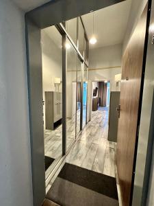 a hallway of a building with a door and a room at Royal City Centre Apartment in Poprad