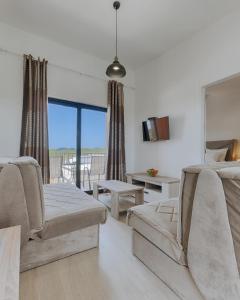 a living room with two chairs and a couch at Family Resort in Ulcinj