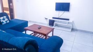 sala de estar con sofá azul y mesa en One Bedrooms with 2 Bed Kisimani Heights Apt, en Mombasa