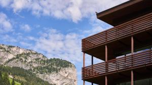 a building with a mountain in the background at Saleghes Dolomites Residence in Selva di Val Gardena