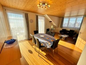 a living room with a table and a dining room at Burgheim Siesta in Oberhofen am Thunersee