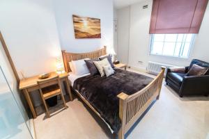 a bedroom with a bed and a desk and a chair at StayInn Aldgate East in London