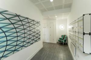 a hallway with a room with a glass wall at StayInn Aldgate East in London