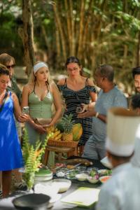a group of people standing around a table with food at Athgira River Camping - Udawalawe in Udawalawe