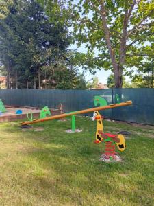 a park with a playground with a seesaw at Domek nad Krutynią in Piecki