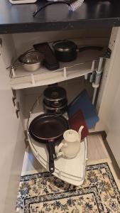 a cabinet with a stove and a pot and pans at Slattum terrasse in Skytta
