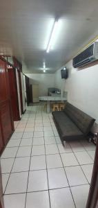 an empty room with a couch and a table at Hotel Allan Veintiocho Puntarenas in Puntarenas