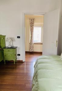 - une chambre avec un lit vert et une fenêtre dans l'établissement Country Apartament - Malpassuti, à Carbonara Scrivia