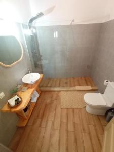 a bathroom with a white toilet and a sink at Archontiko tis Irinis in Ádhele +52 photos