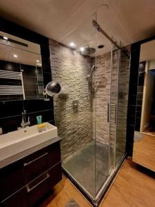 a bathroom with a glass shower and a sink at 500-Mb Hi-Tech Silent Work-Home in Amsterdam