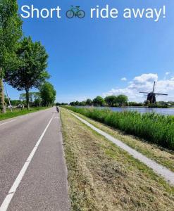 a road with a bike and a windmill on the side at 500-Mb Hi-Tech Silent Work-Home in Amsterdam