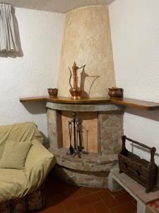 a living room with a stone fireplace with a shelf at Casa Ceragioli in Viareggio