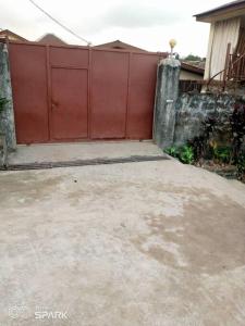 a large red gate in front of a house at 2 bedroom Bungalow @ St John in Mount Aureol
