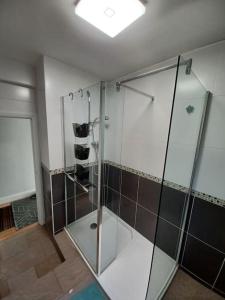 a bathroom with a shower with a glass enclosure at The Gem - central character flat with parking in Southampton
