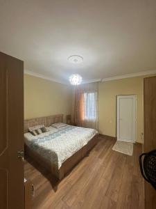 a bedroom with a large bed and a window at Los-Polos Hermanos in Batumi +4 photos