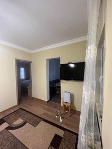 an empty living room with a flat screen tv at Los-Polos Hermanos in Batumi