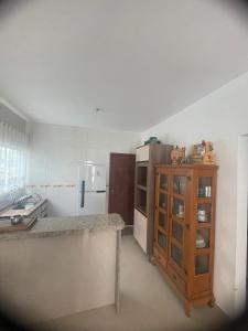 a kitchen with a counter and a refrigerator at Praia dos ingleses Floripa in Florianópolis