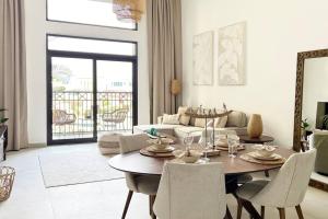 a living room with a table and a couch at Post Modern Near Burj Al Arab in Dubai