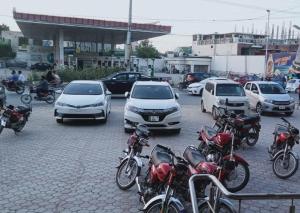 a group of motorcycles parked in a parking lot at King's Paradise in Lahore