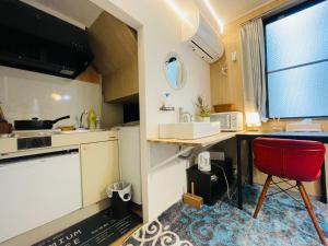 a kitchen with a table and a red chair at Sky house晴空塔2 in Tokyo