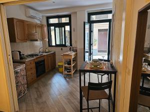 a kitchen with a table and a counter top at Casa Ponturo in Taormina