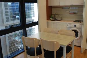 a kitchen with a table and chairs and a washing machine at Samseong,Coexmall A in Seoul