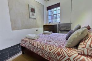 a bedroom with a bed with pillows and a window at 1 bedroom flat near Russel Square in London