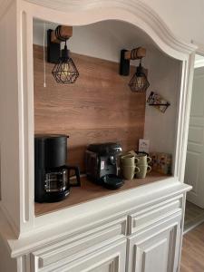 a kitchen counter with a microwave and a coffee maker at Ferienwohnung Seegras in Emden +2 photos