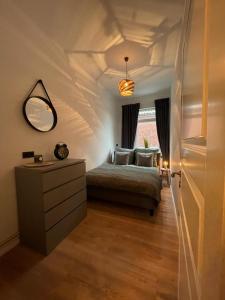 1 dormitorio con cama, tocador y espejo en Ferienwohnung Seegras, en Emden