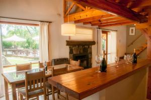 a dining room with a table and a fireplace at Aldeas de Vacaciones - Feriendorf in Villa General Belgrano