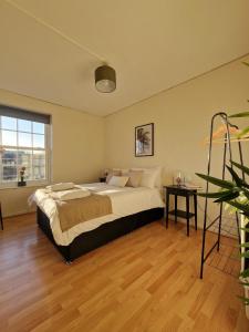 a bedroom with a large bed and a table at Central location in London