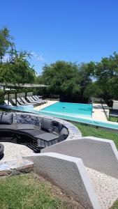 a large swimming pool with a slide in the grass at A Hotel Decosuites in Merlo