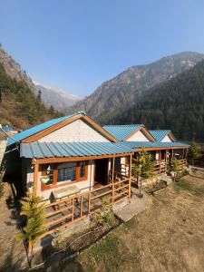 an overhead view of a house with a blue roof at Lee Garden Himalayan Wooden Cottages in Kasol